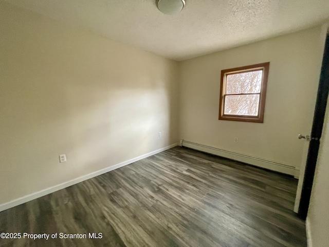 1211 Jackson St 1209-, Scranton, PA 18504 - empty room with baseboard heating, dark wood finished floors, baseboards, and a textured ceiling