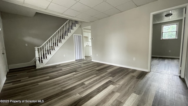1211 Jackson St 1209-, Scranton, PA 18504 - unfurnished living room featuring wood finished floors, baseboards, stairway, and a drop ceiling