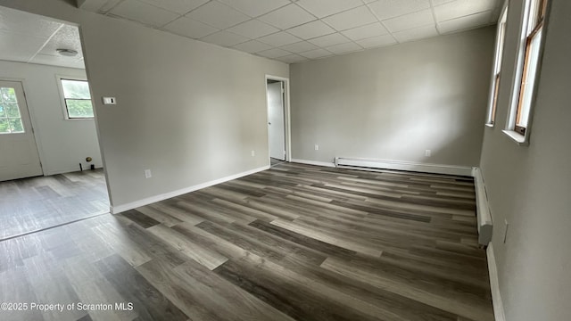 1211 Jackson St 1209-, Scranton, PA 18504 - unfurnished room featuring baseboard heating, dark wood-style flooring, baseboards, and a paneled ceiling