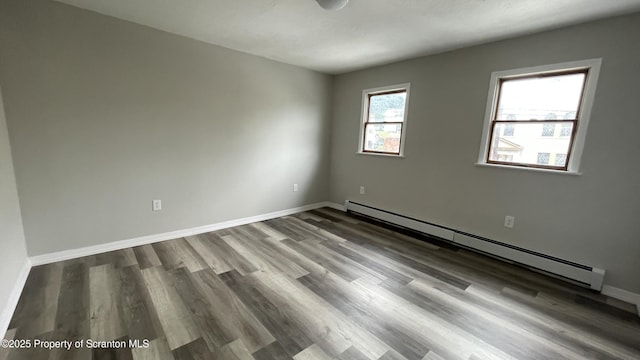 1211 Jackson St 1209-, Scranton, PA 18504 - empty room featuring baseboard heating, wood finished floors, and baseboards