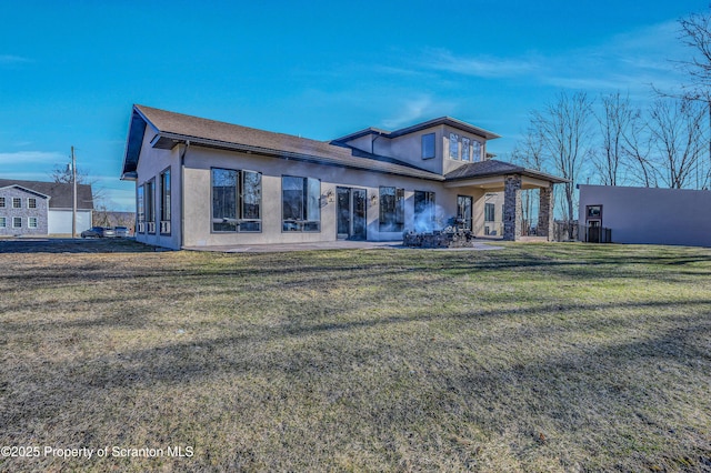 815 Oak St, Archbald, PA 18403 - rear view of house with stucco siding and a lawn