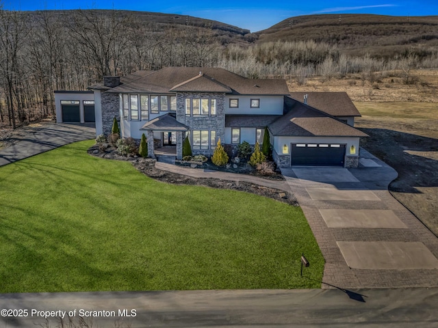 815 Oak St, Archbald, PA 18403 - view of front of property with a front yard, stucco siding, driveway, stone siding, and an attached garage