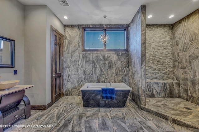 815 Oak St, Archbald, PA 18403 - bathroom featuring a bathing tub, visible vents, an inviting chandelier, recessed lighting, and tile walls