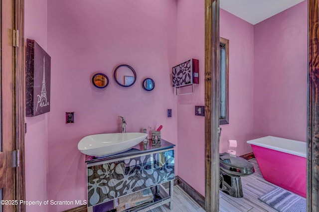 815 Oak St, Archbald, PA 18403 - bathroom with toilet, wood finished floors, baseboards, a soaking tub, and vanity