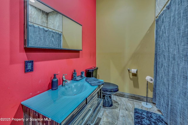 815 Oak St, Archbald, PA 18403 - bathroom with toilet, vanity, and baseboards