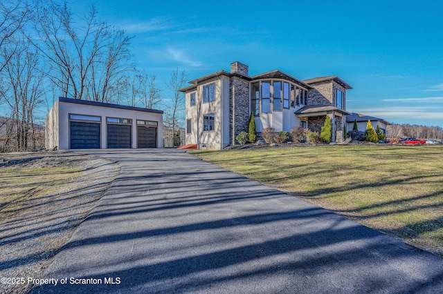 815 Oak St, Archbald, PA 18403 - contemporary home featuring stucco siding, a detached garage, an outdoor structure, and a front yard