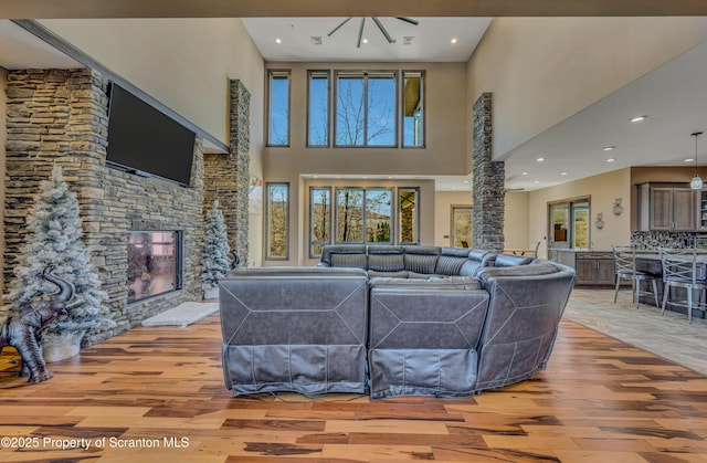 815 Oak St, Archbald, PA 18403 - living room with recessed lighting, a high ceiling, light wood-style flooring, and a fireplace