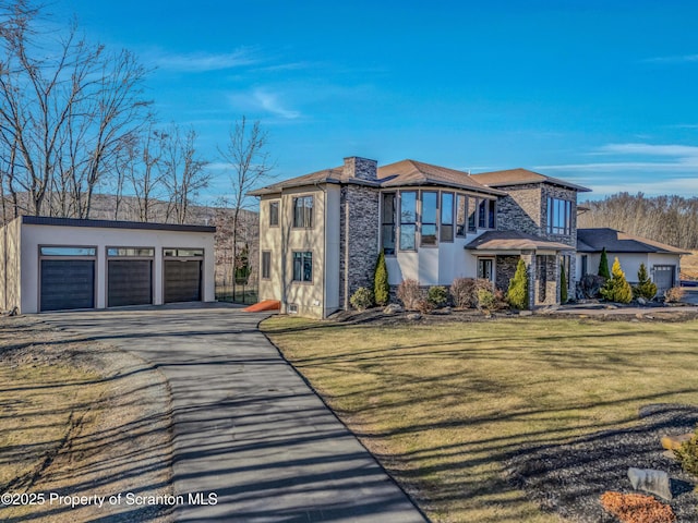 815 Oak St, Archbald, PA 18403 - view of front facade featuring driveway, stucco siding, a front lawn, an outdoor structure, and a garage
