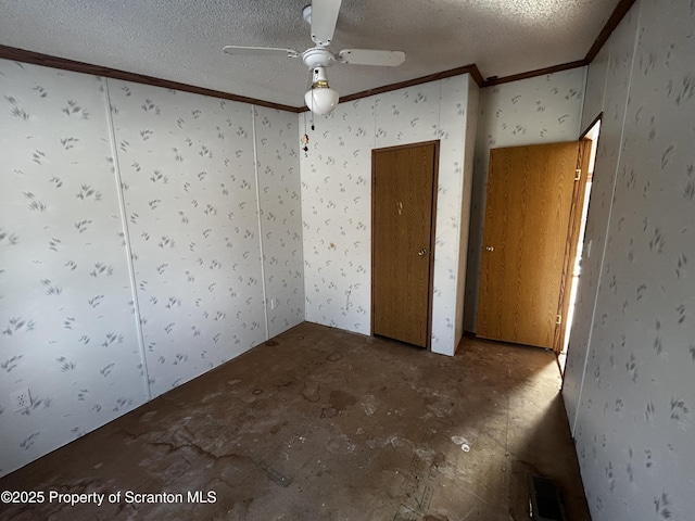 unfurnished bedroom featuring a ceiling fan, visible vents, ornamental molding, and a textured ceiling