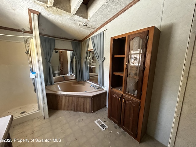 bathroom with visible vents, vaulted ceiling, a shower stall, a textured ceiling, and a bath