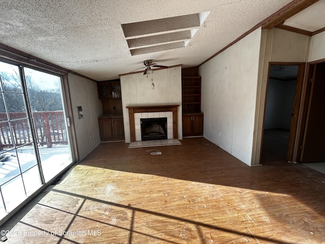 unfurnished living room with hardwood / wood-style flooring, a fireplace, and crown molding