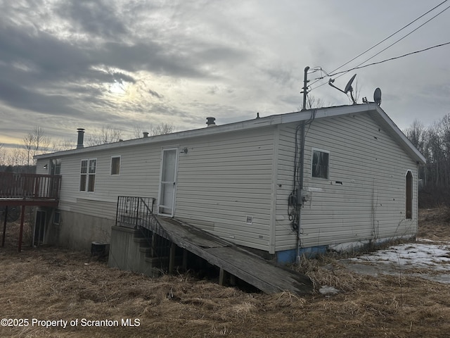 back of house with central AC