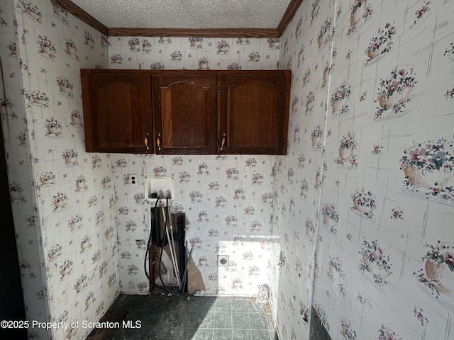 laundry area featuring ornamental molding, tile patterned floors, a textured ceiling, and wallpapered walls