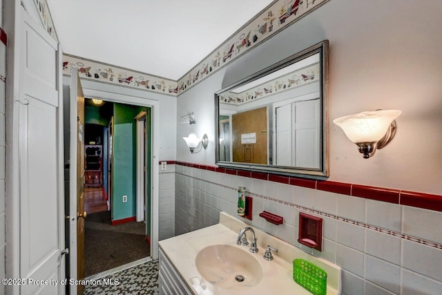 bathroom featuring tile walls and vanity