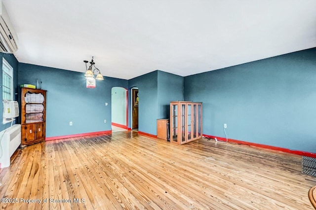 interior space featuring wood-type flooring and radiator heating unit