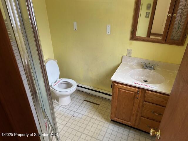 bathroom with toilet, a baseboard radiator, an enclosed shower, and vanity