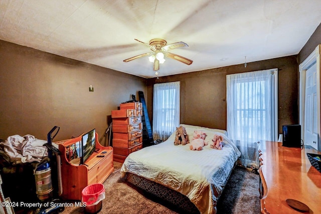 bedroom featuring multiple windows and ceiling fan