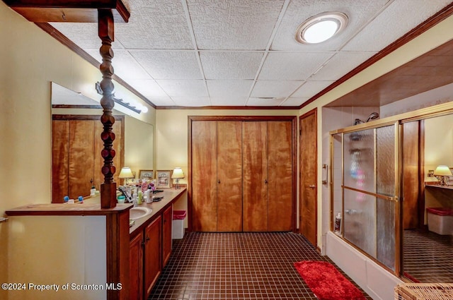 bathroom featuring vanity, a drop ceiling, and crown molding