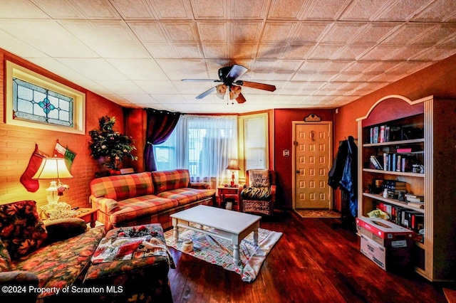 living room with dark hardwood / wood-style flooring and ceiling fan