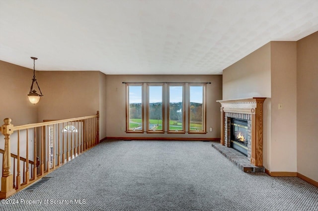 unfurnished living room featuring carpet and a fireplace