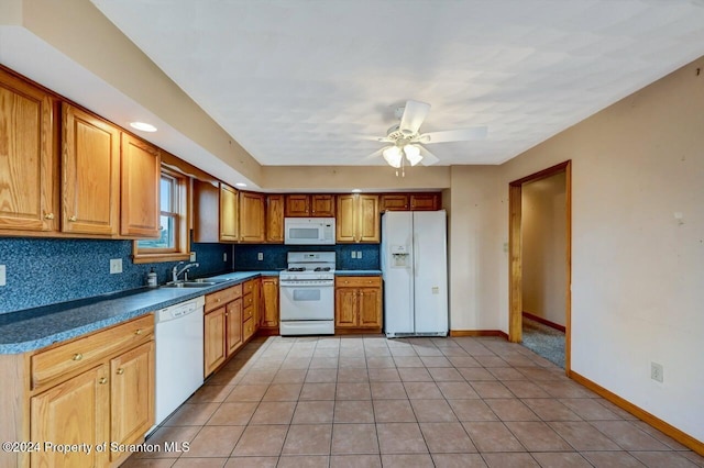 kitchen featuring white appliances, sink, light tile patterned floors, and tasteful backsplash