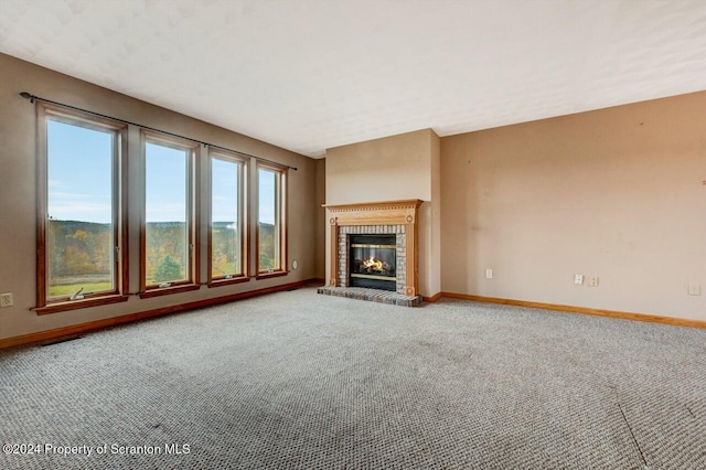 unfurnished living room featuring carpet and a fireplace