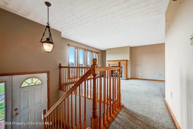 stairs with carpet floors and plenty of natural light