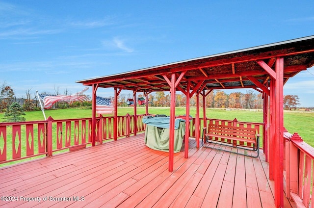 wooden deck featuring a lawn