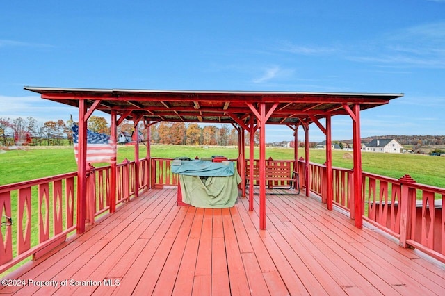 wooden deck featuring a yard