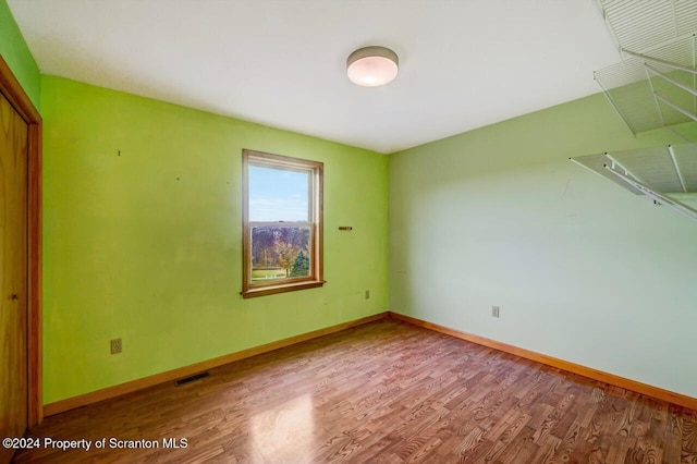 empty room with hardwood / wood-style flooring