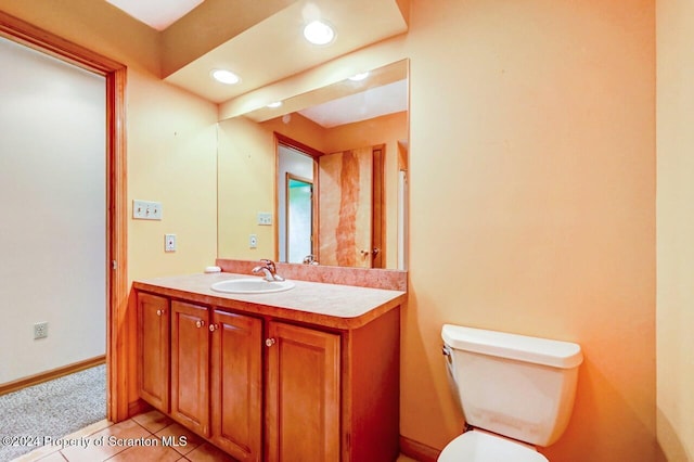 bathroom with tile patterned floors, vanity, and toilet