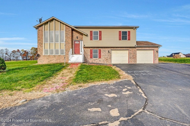 bi-level home with a garage and a front yard