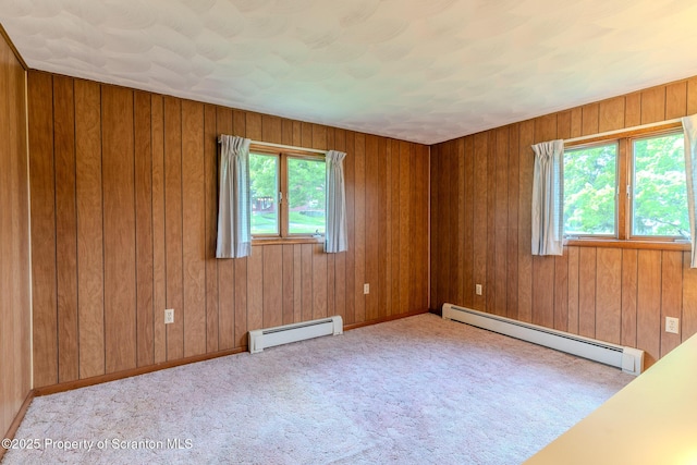 474 Tingley Lake Rd, New Milford, PA 18834 - carpeted spare room featuring a baseboard heating unit and wooden walls