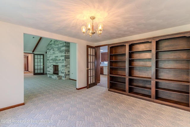 474 Tingley Lake Rd, New Milford, PA 18834 - unfurnished living room with carpet flooring, a chandelier, baseboards, a fireplace, and vaulted ceiling