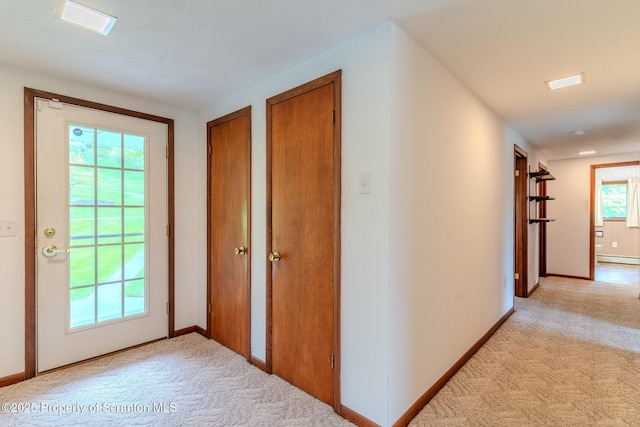 474 Tingley Lake Rd, New Milford, PA 18834 - hallway featuring light colored carpet, a baseboard heating unit, and baseboards