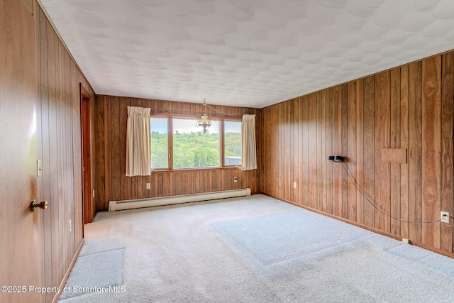 474 Tingley Lake Rd, New Milford, PA 18834 - empty room with a baseboard heating unit, carpet floors, and wooden walls
