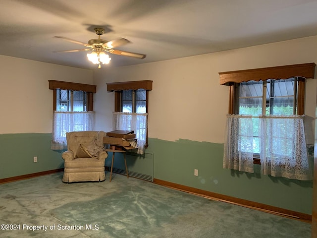 unfurnished room with ceiling fan and carpet floors