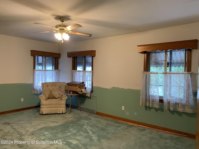 unfurnished room featuring ceiling fan and carpet floors