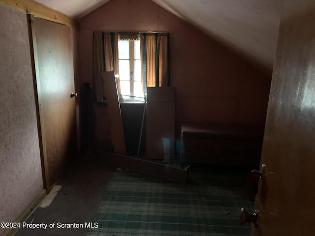 stairway featuring lofted ceiling