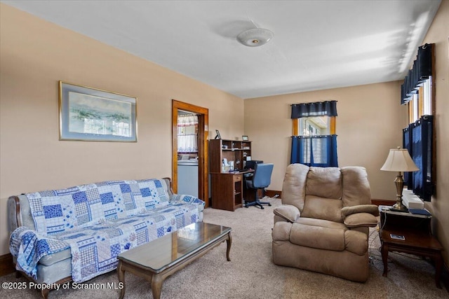 living room featuring carpet floors and baseboards