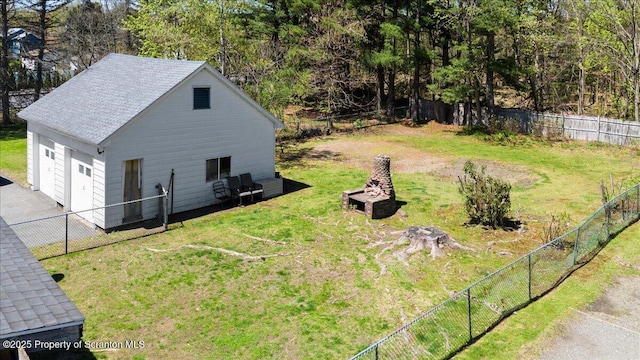 view of yard featuring a fenced backyard and a detached garage