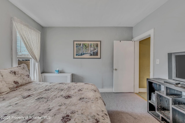 carpeted bedroom featuring baseboards