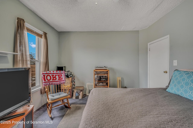 bedroom featuring a textured ceiling and carpet floors