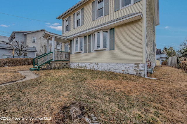 view of side of property with a lawn