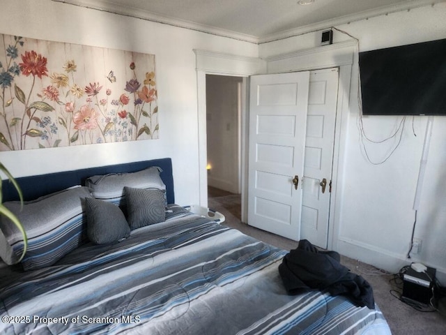 bedroom with carpet floors, a closet, and crown molding