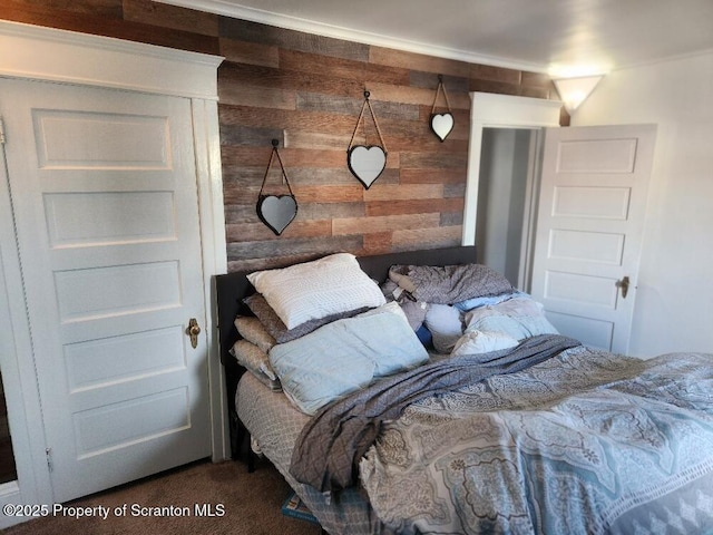 carpeted bedroom with wooden walls