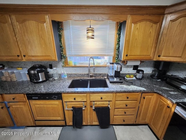 kitchen featuring dishwasher, dark stone counters, a sink, and decorative backsplash