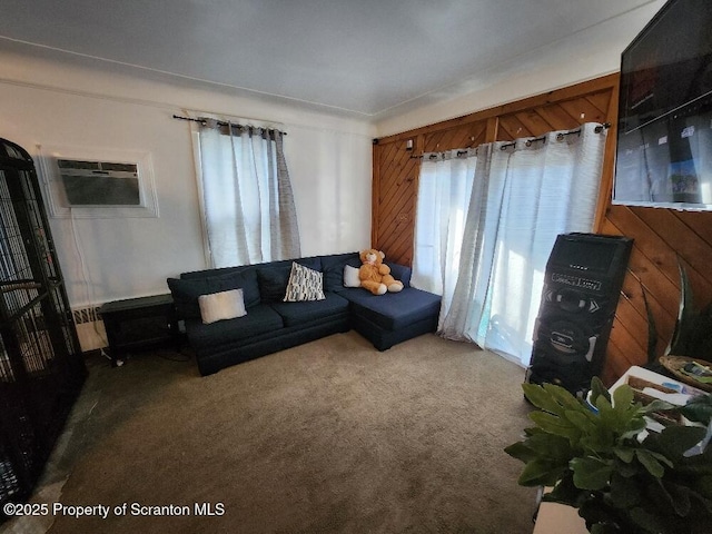 carpeted living area featuring plenty of natural light and a wall mounted AC