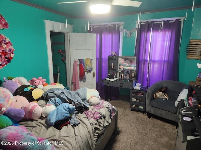 carpeted bedroom with ceiling fan and crown molding