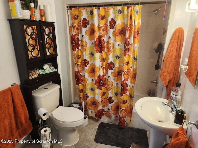 full bathroom with a sink, toilet, and tile patterned floors